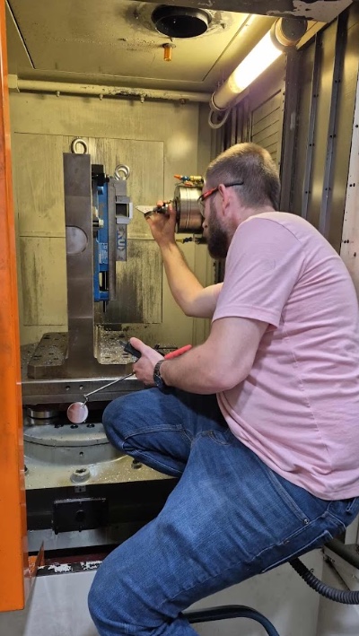 Montgomery Precision machinist indicating a fixture inside the Fortune HV500 horizontal machining center