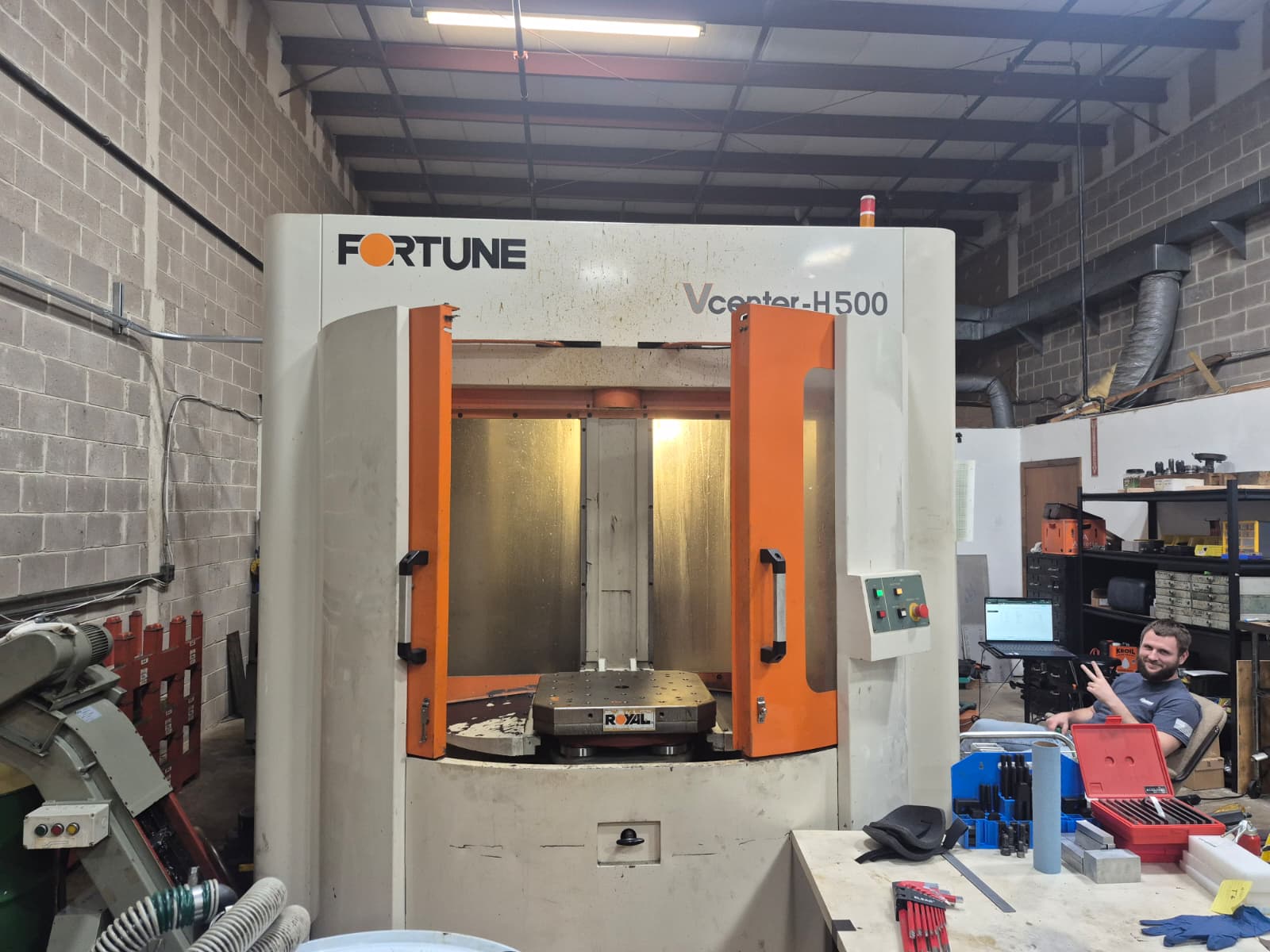 Front view of the Fortune HV500 horizontal machining center with its doors open and rotary pallet visible