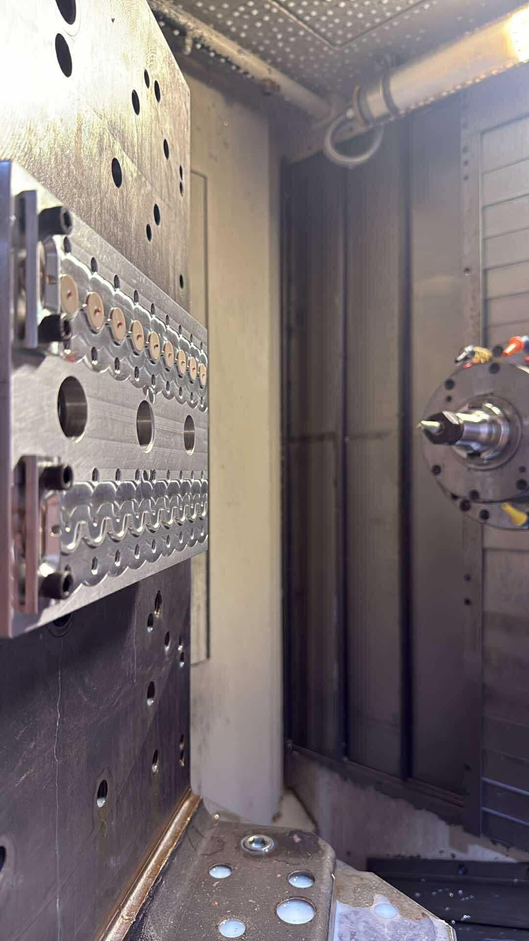 Multi-part fixture plate mounted on a tombstone in the horizontal mill