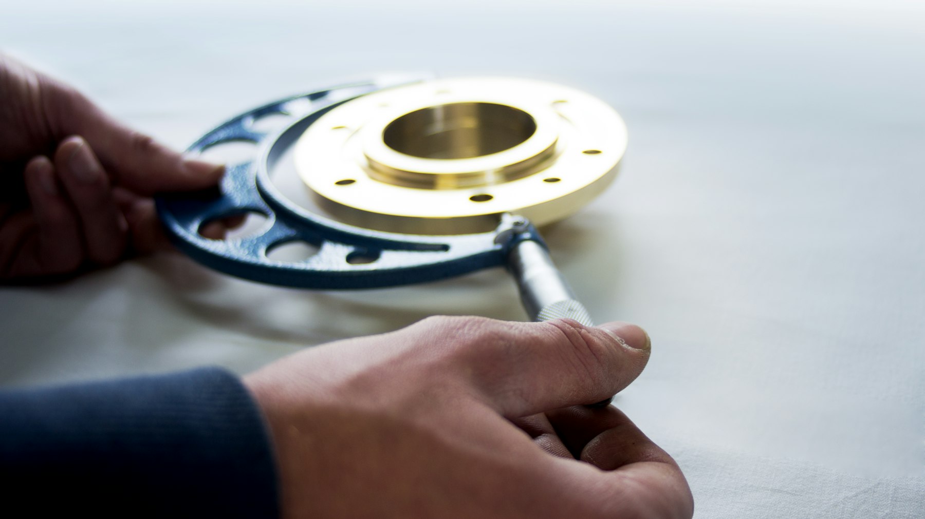 Digital caliper measuring the bore of a machined flange