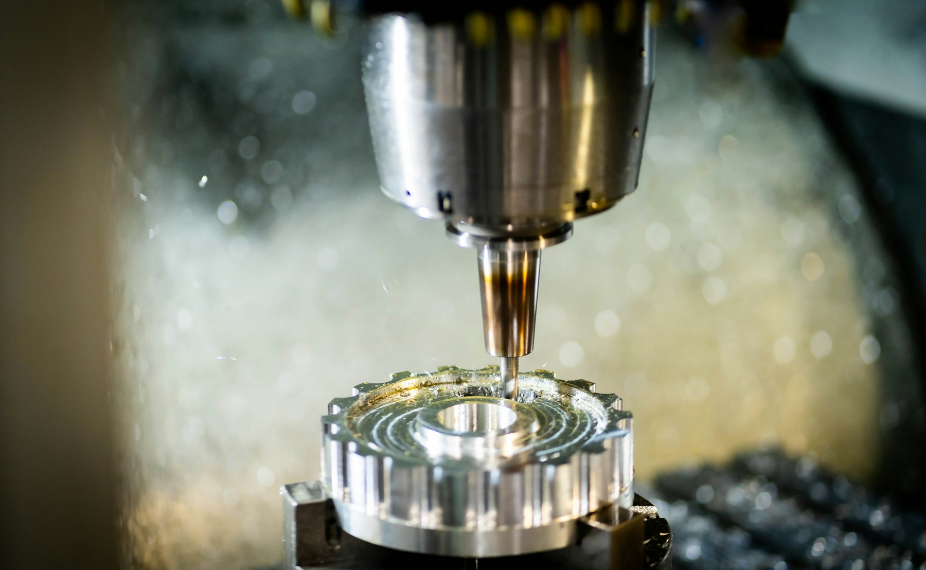Face mill finishing a round steel part under coolant