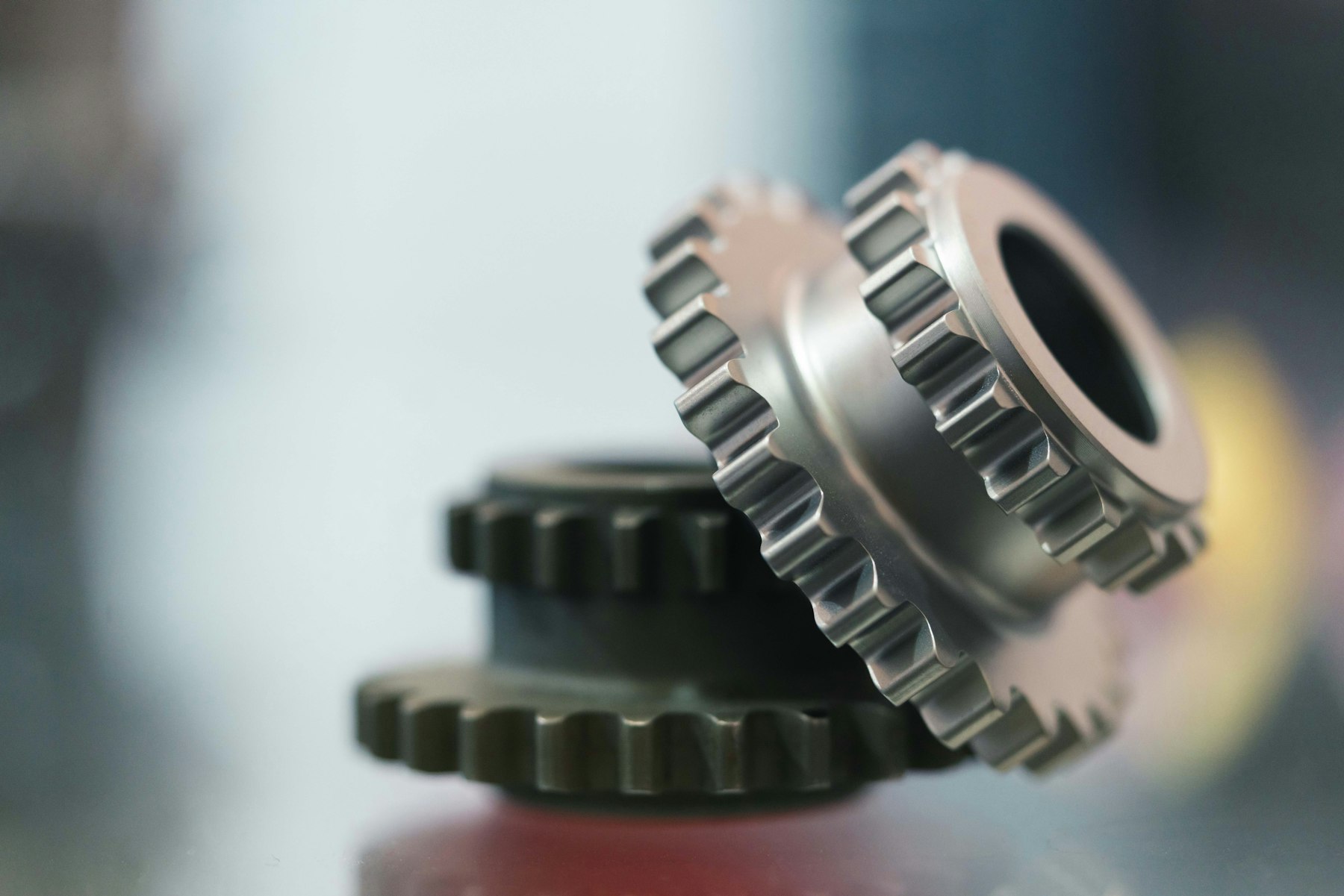 Two machined steel gears stacked on a bench