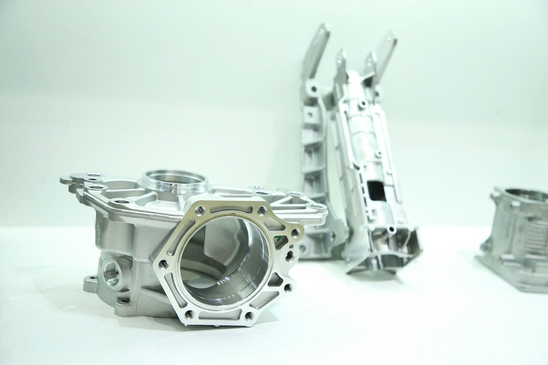 Several machined aluminum housings and brackets on a bench